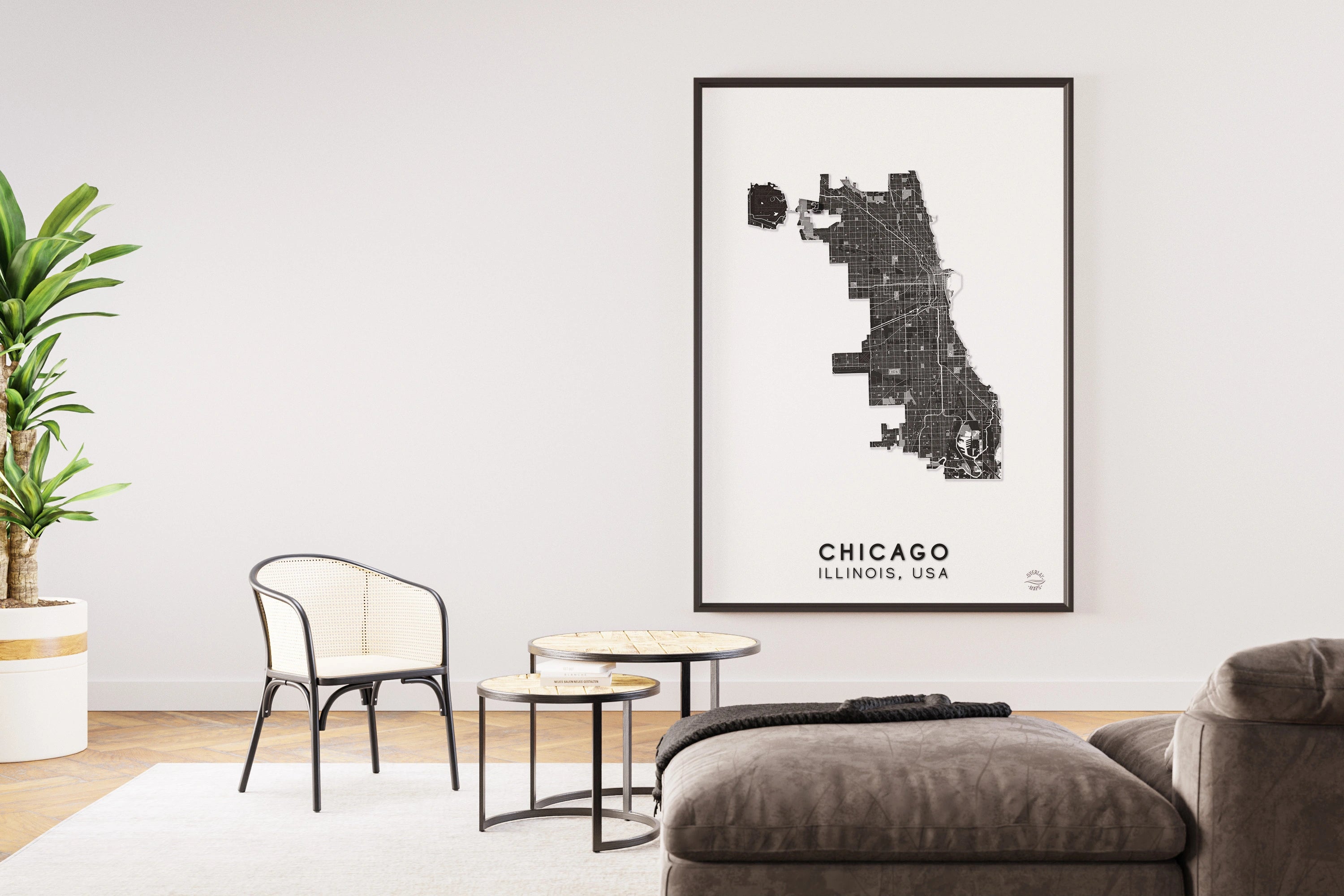 Header image. Shows a living room with a map of Chicago, Illinois, USA in Black and white with details of the roads. The livingroom background is white, has a sofa, plants and chairs. 